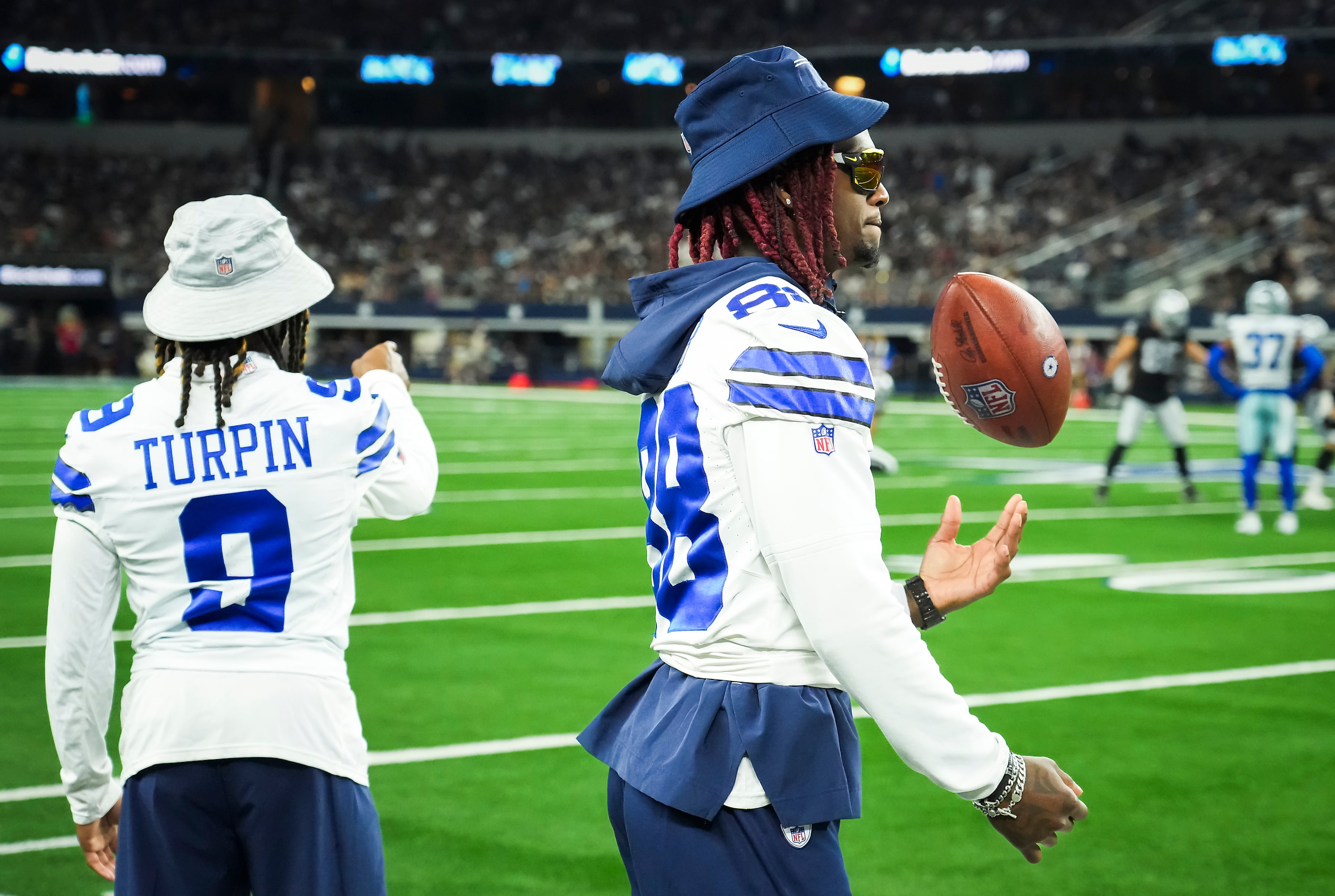 Dallas Cowboys wide receivers CeeDee Lamb (88) and KaVontae Turpin (9) watch from the...