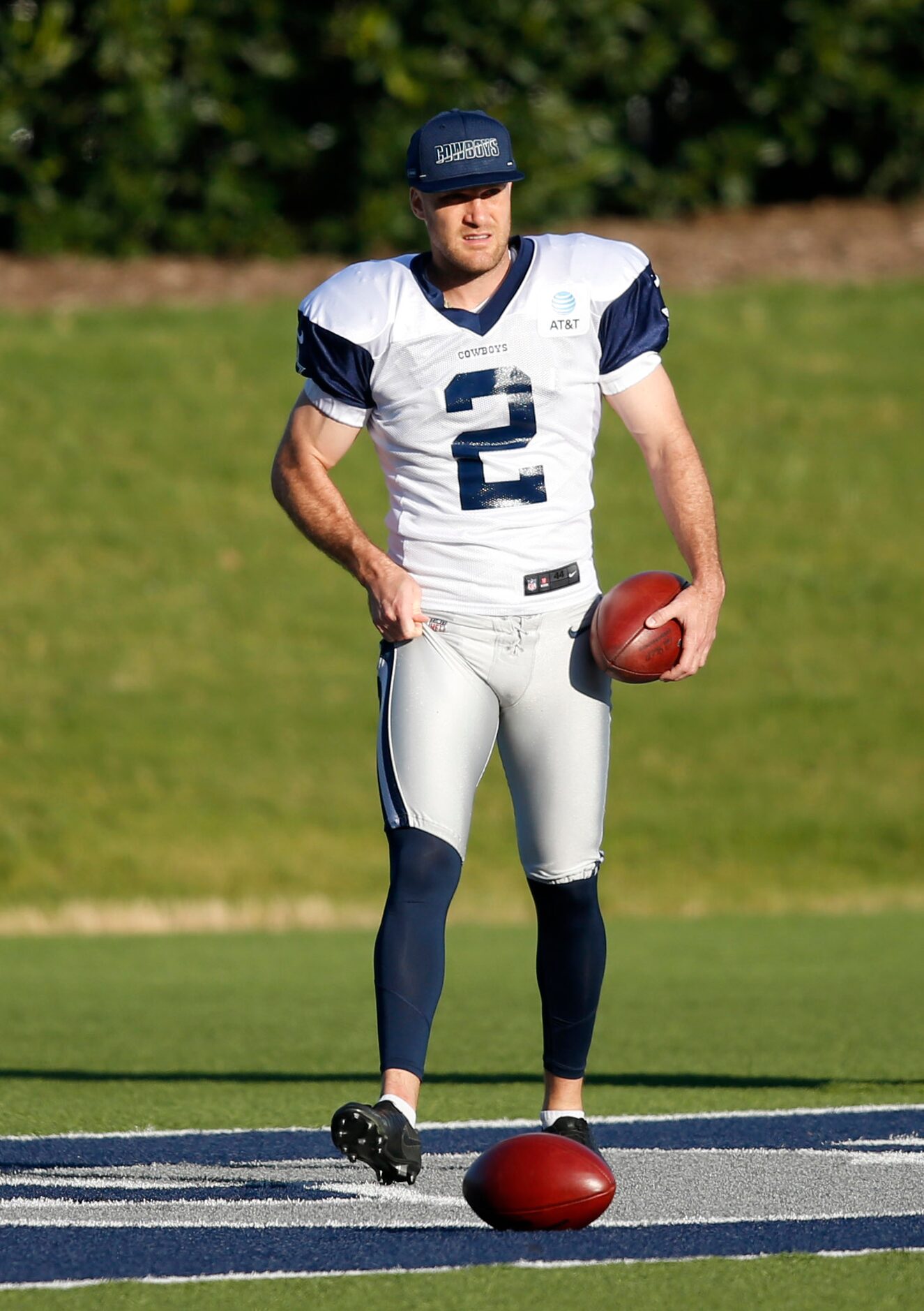 Dallas Cowboys place kicker Greg Zuerlein (2) gathers footballs in practice during training...