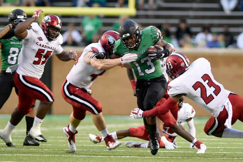 North Texas running back DeAndre Torrey (13) carries the ball against Incarnate Word during...