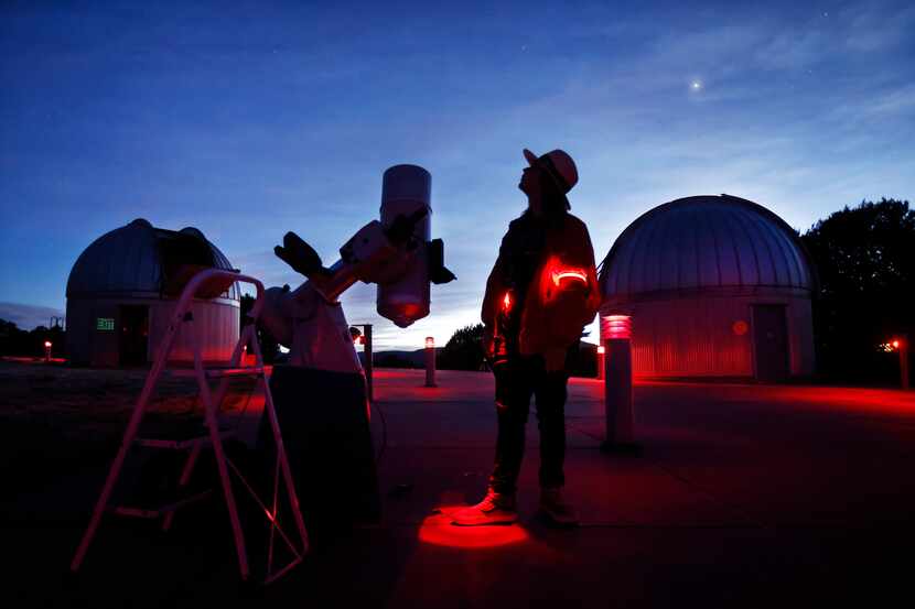 Telescope operator Tommy LePori looks skyward as he sets an 8” telescope for a Star Party in...