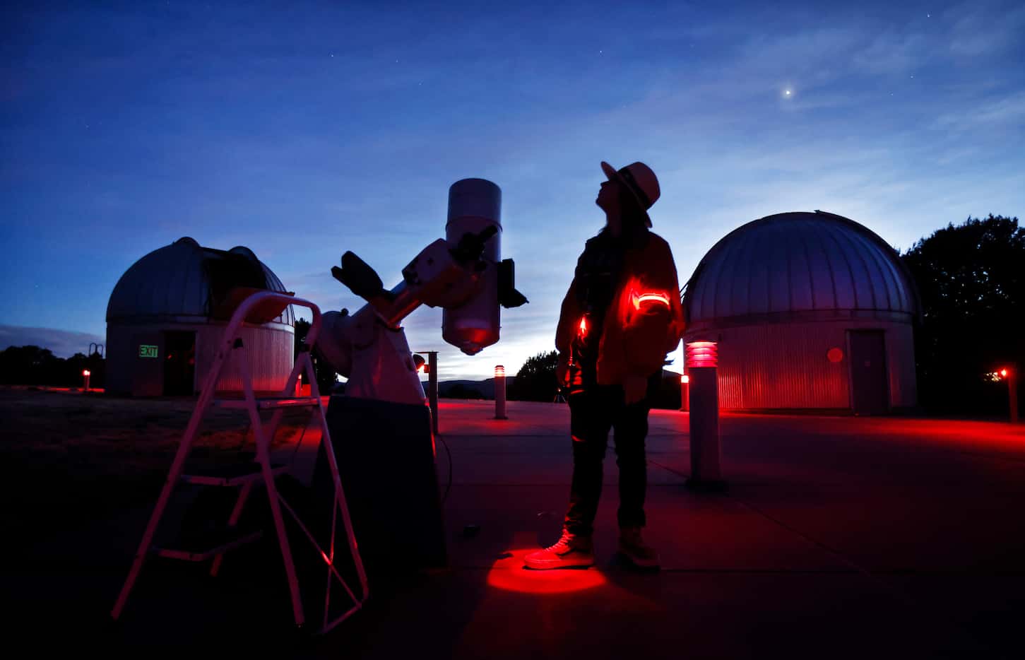 Telescope operator Tommy LePori looks skyward as he sets an 8” telescope for a star party in...