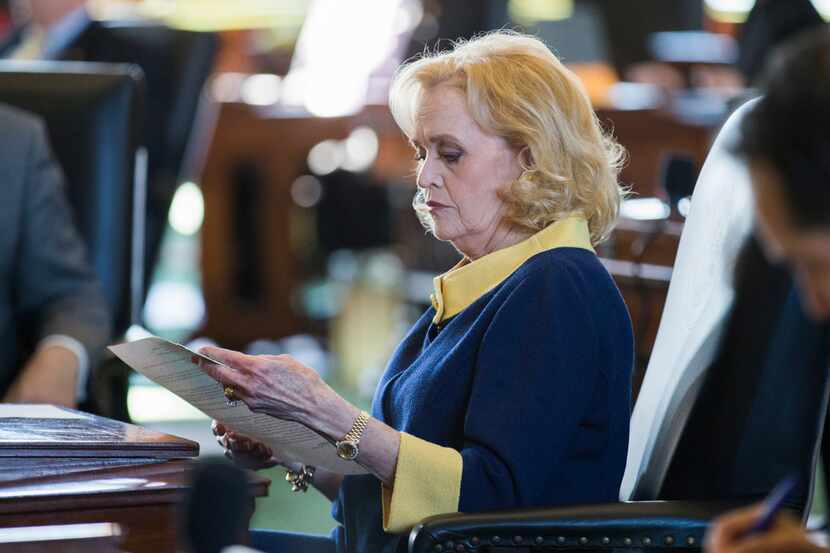 Senator Beverly Powell looks over documents at her desk on the second day of the 86th Texas...