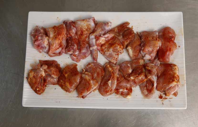 Chicken and rabbit pieces rubbed with spices. 