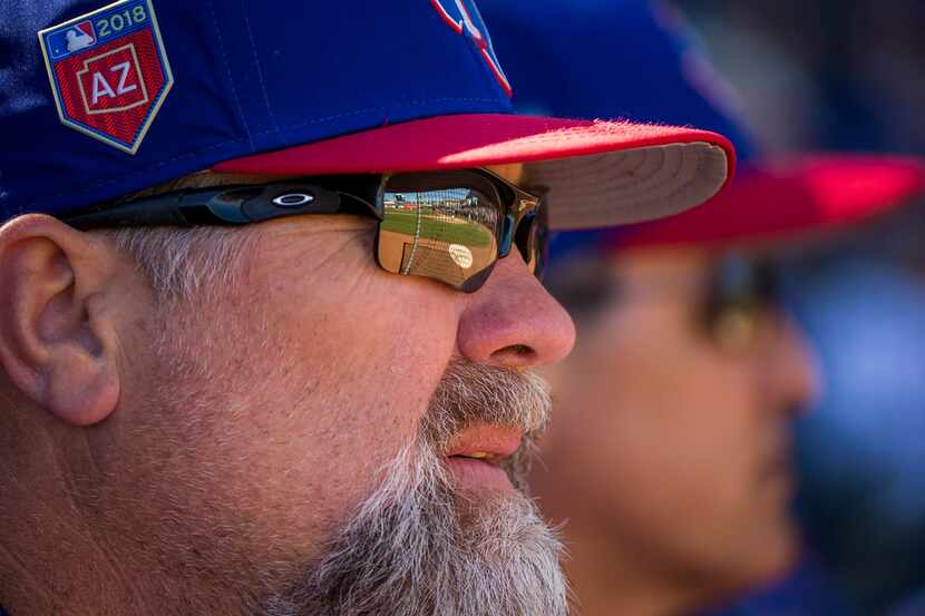 Texas Rangers pitching coach Doug Brocail watches a spring training baseball game against...