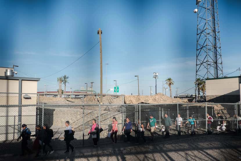 Migrants are released from an immigration holding facility nearby the Sante Fe Bridge in El...