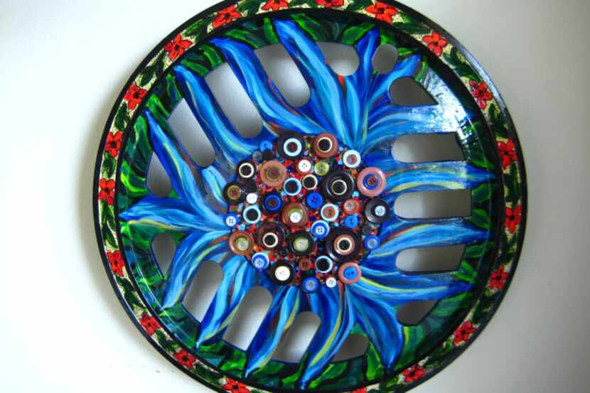 Sharon Zigrossi, a Dallas artist, paints and decorates hubcaps she finds discarded on the...
