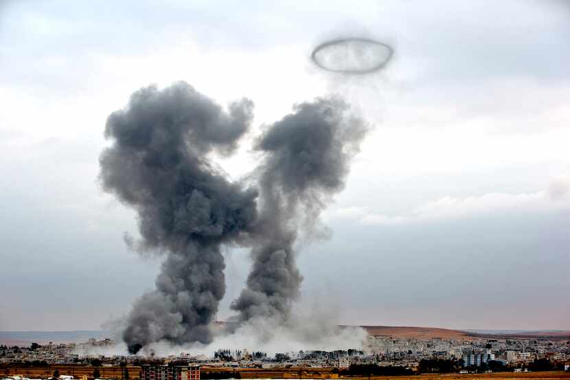  Smoke rises from the Syrian city of Kobani, following airstrikes by the US led coalition,...