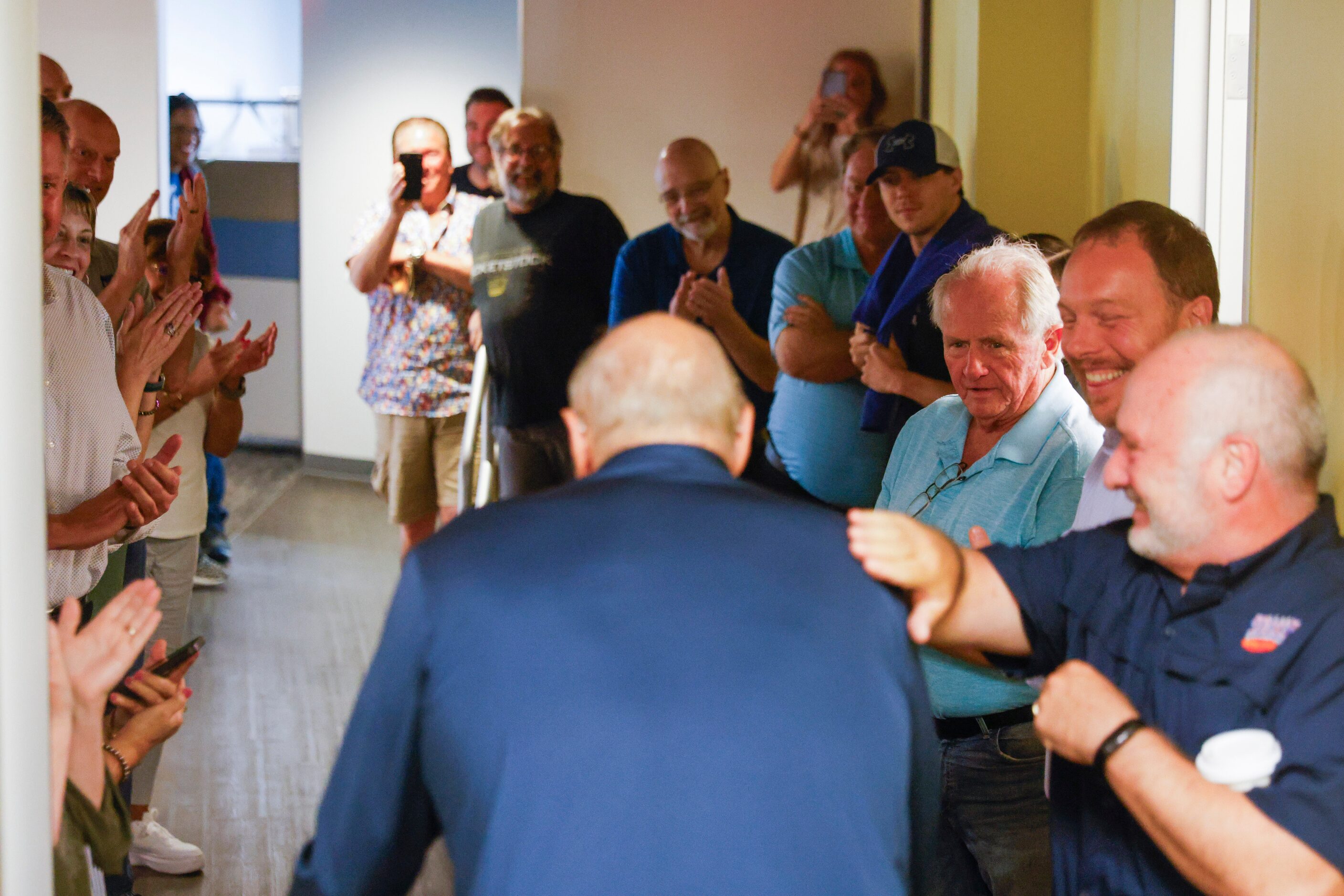 Crowd cheers as local sports radio legend Norm Hitzges walks through a honor walk after his...