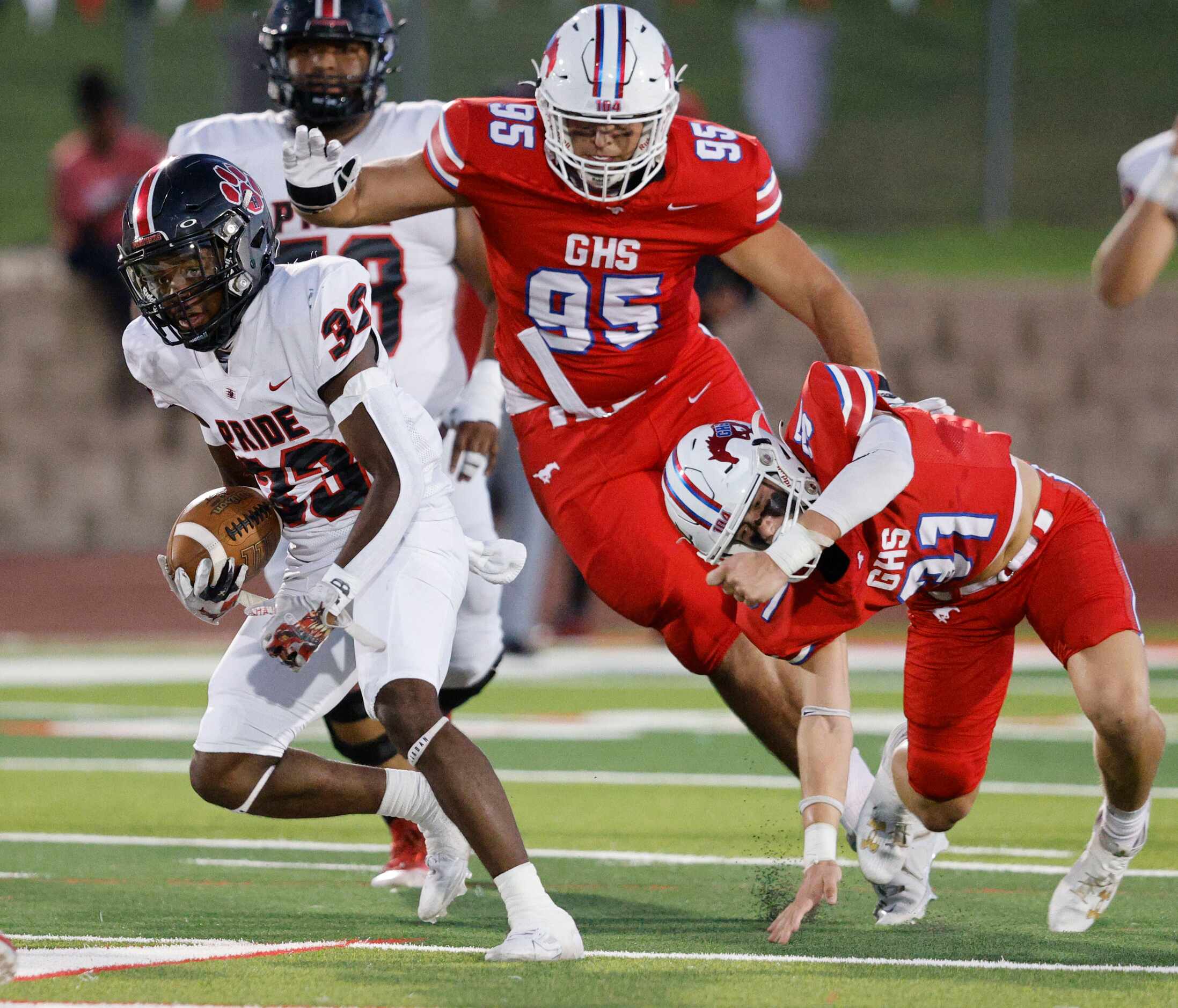 Colleyville Heritage's Colin Bennett (33) keeps a ball away from Grapevine's Cooper Towery...