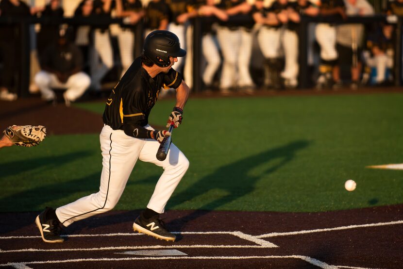 Forney second baseman Garret Hendricks (22) bunts during a baseball game between Crandall...