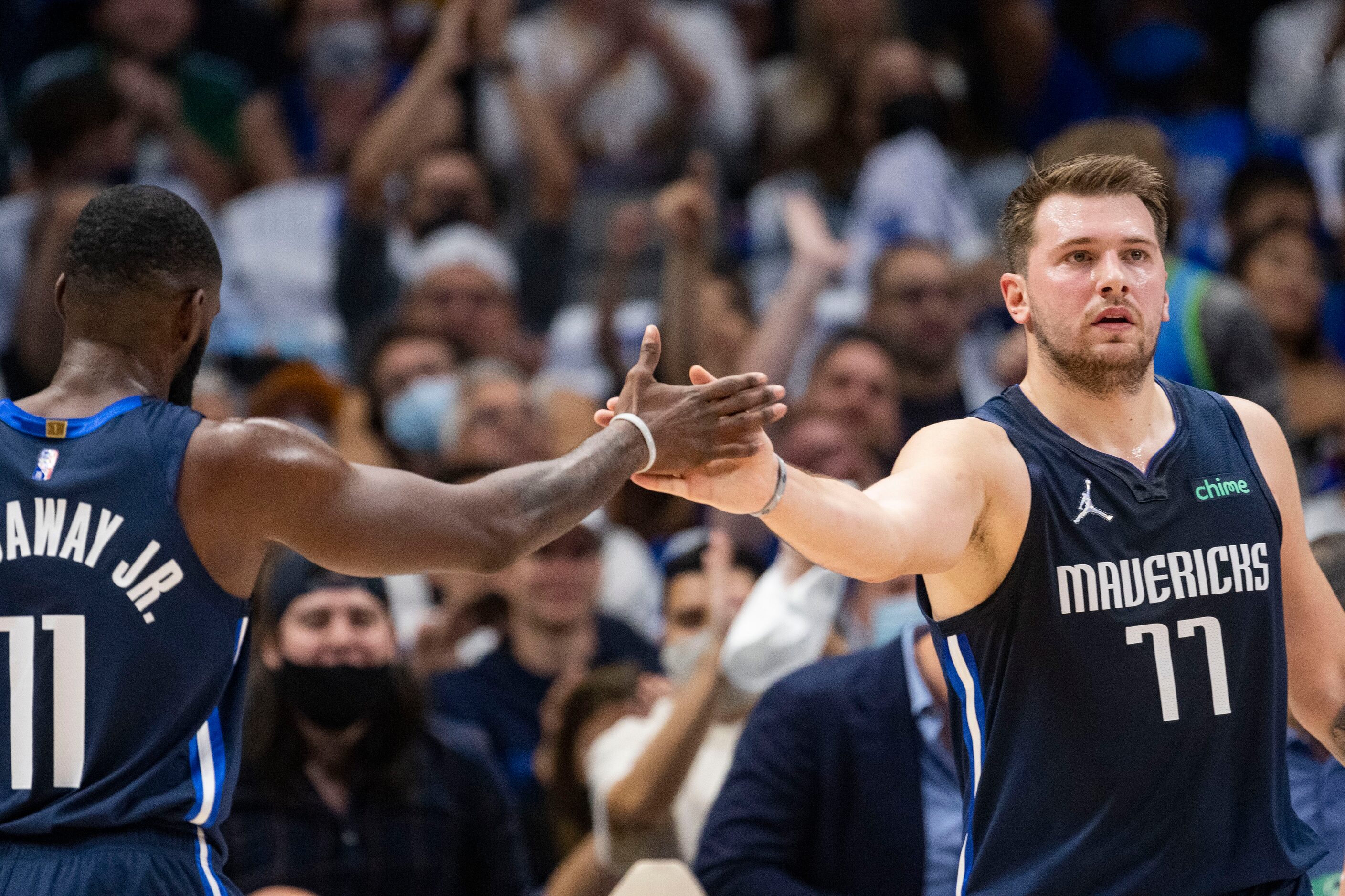 Dallas Mavericks forward Tim Hardaway Jr. (11) high fives Dallas Mavericks guard Luka Dončić...