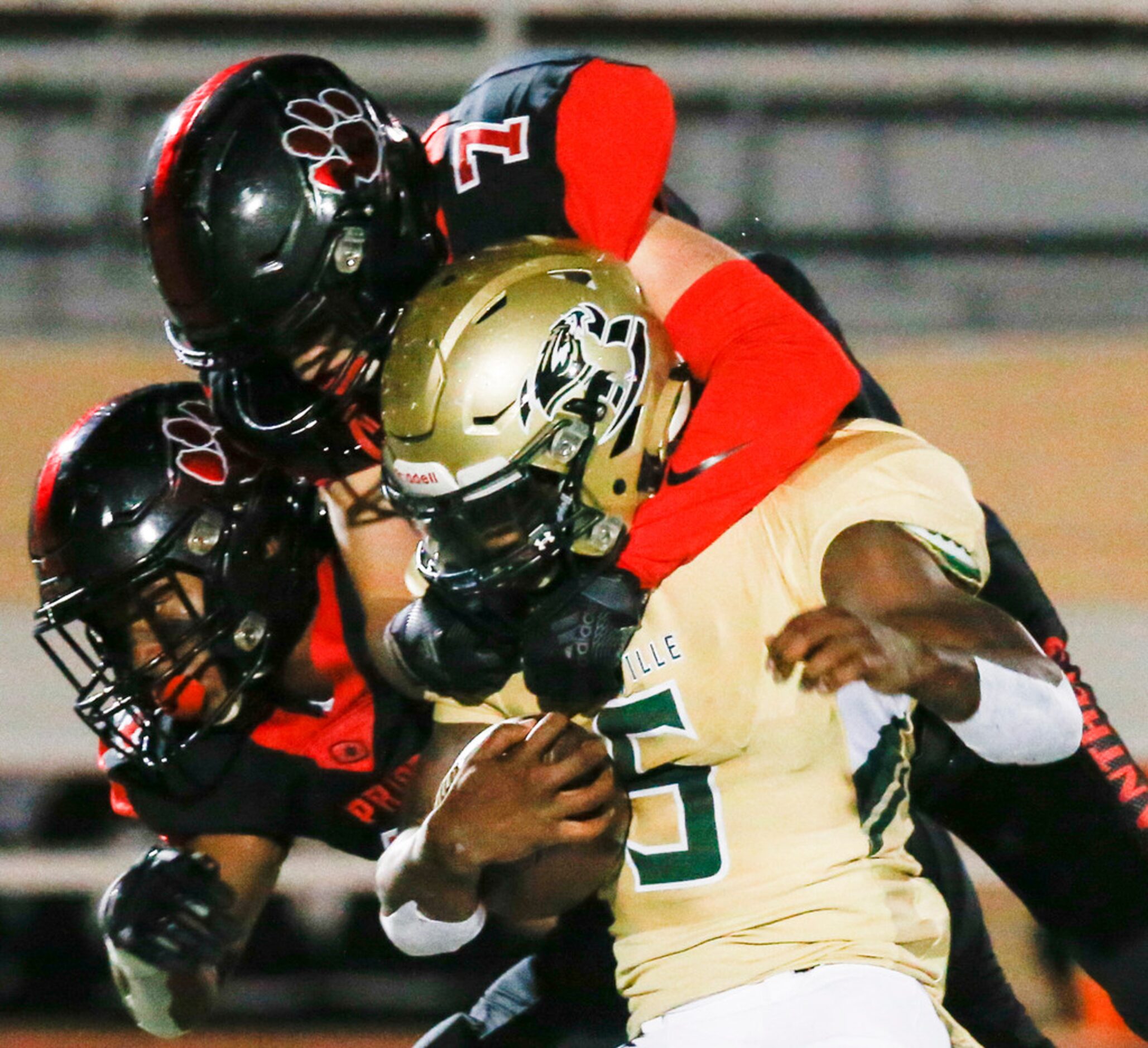 Colleyville Heritage defensive back Joshua Dobbins (11) and safety Luke Made (7) work to...