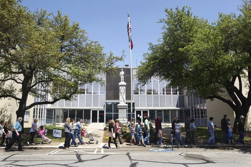 Residents take part in a prayer walk around the Kaufman County Courthouse in Kaufman, Texas...