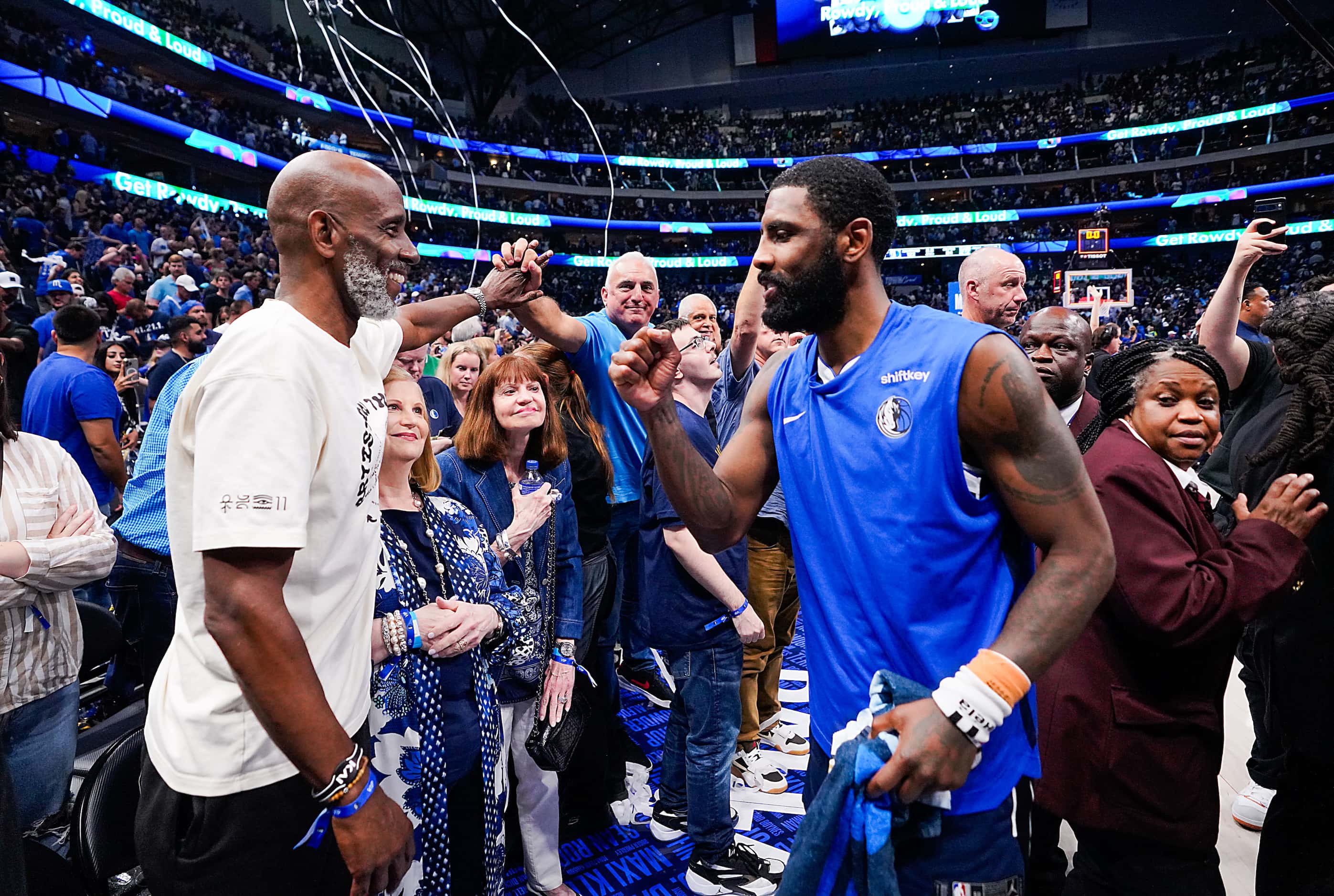 Dallas Mavericks guard Kyrie Irving (11) celebrates with his father Drederick Irving (left)...