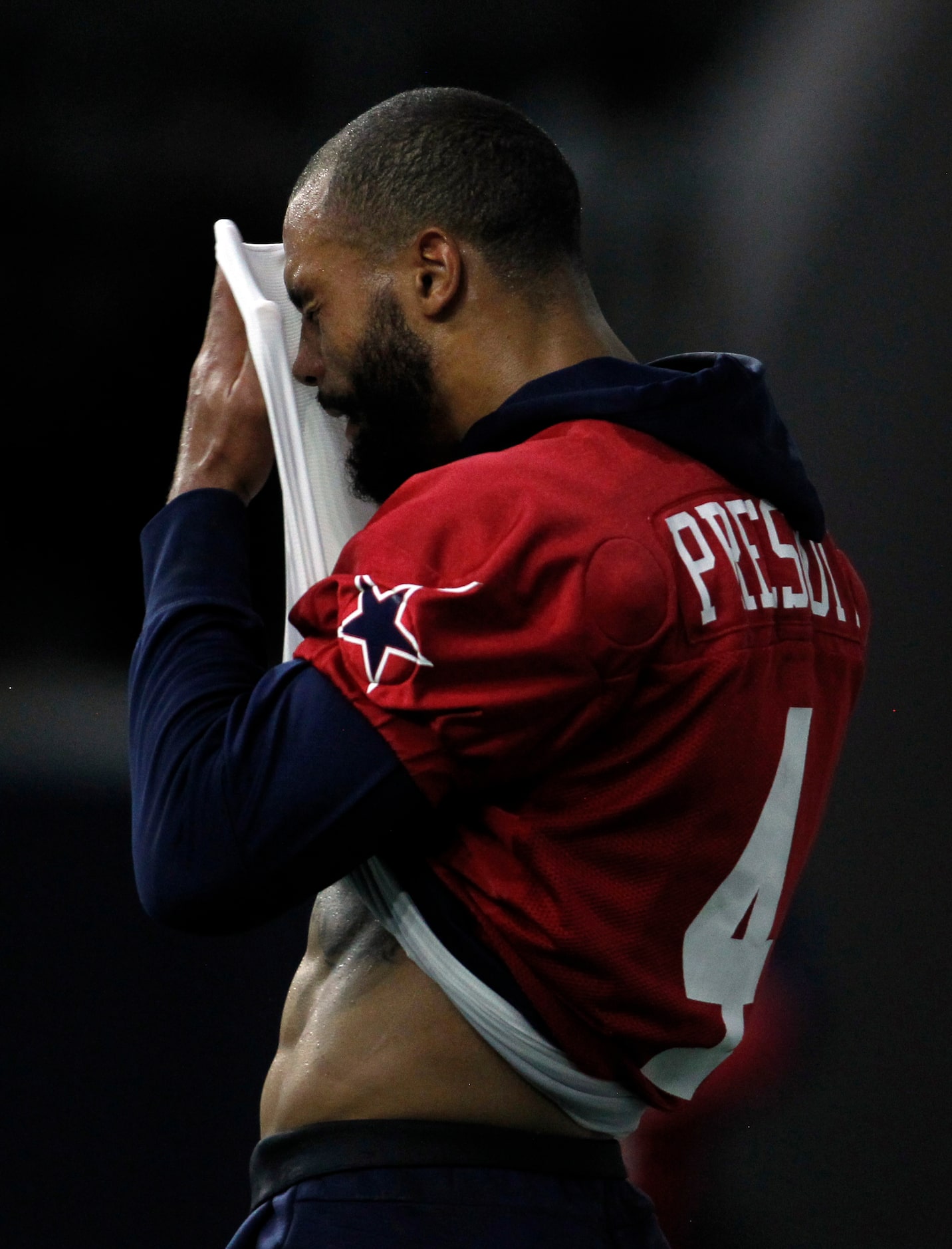 Dallas Cowboys quarterback Dal Prescott (4) wipes perspiration after taking first reps...