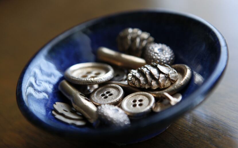 A selection of bronze buttons and other fired precious metal clay pieces made by Metal Clay...
