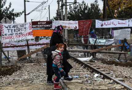  Migrants and refugees cross the Greek-Macedonian border, near Gevgelija, on Dec. 1, 2015....