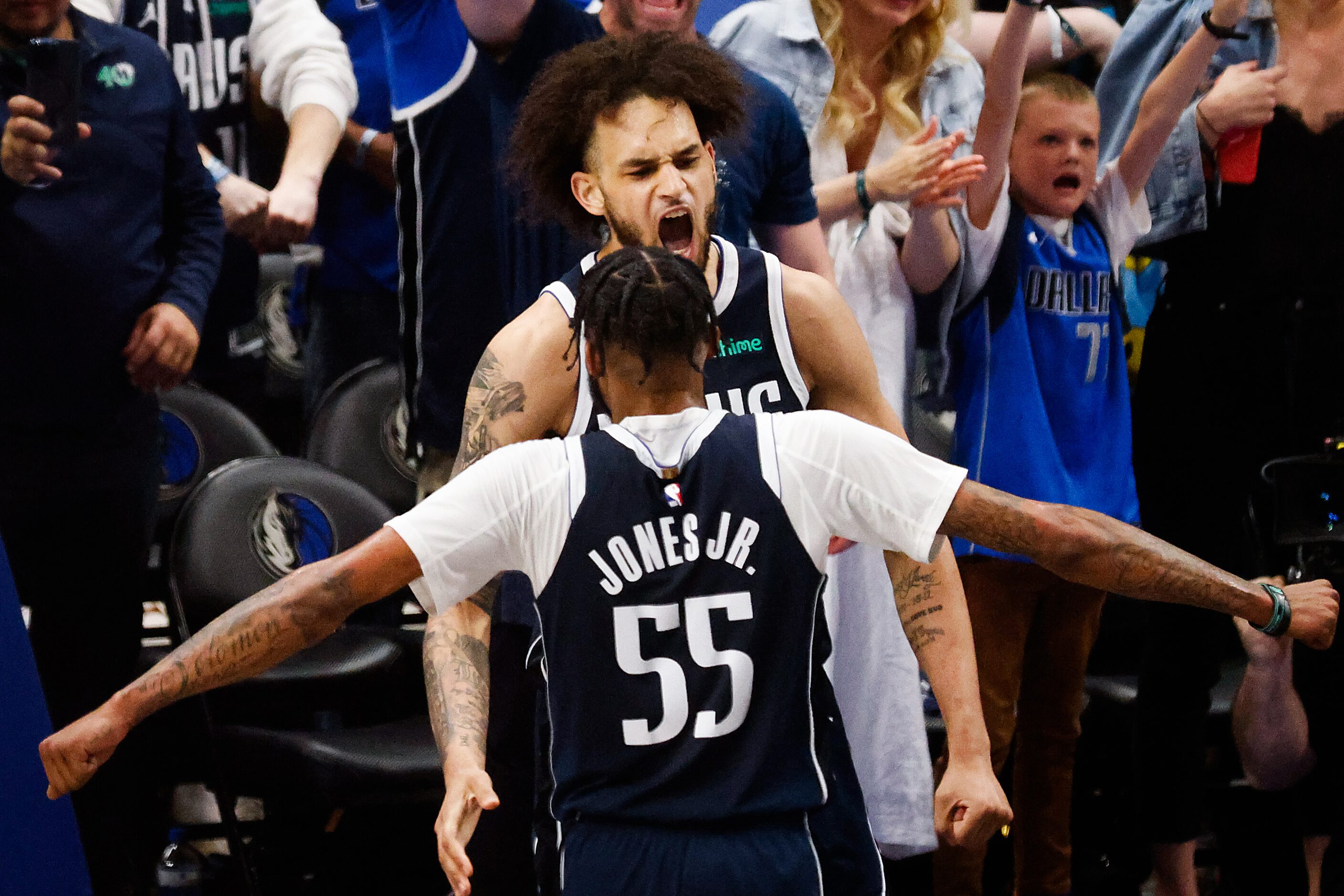 Dallas Mavericks center Dereck Lively II  celebrtes with Derrick Jones Jr. after a dunk...