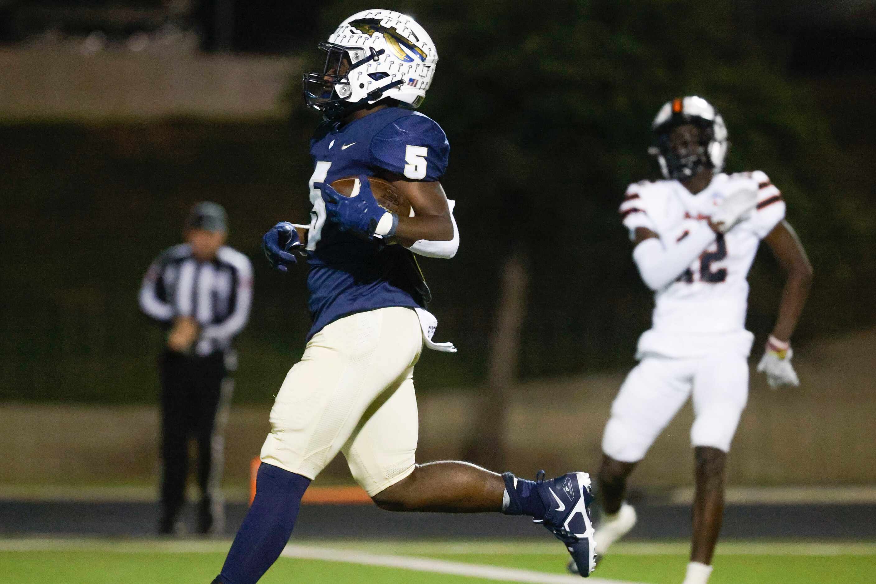 Keller high’s Cameron Rayford (5) scores a touchdown against Haltom high during the second...
