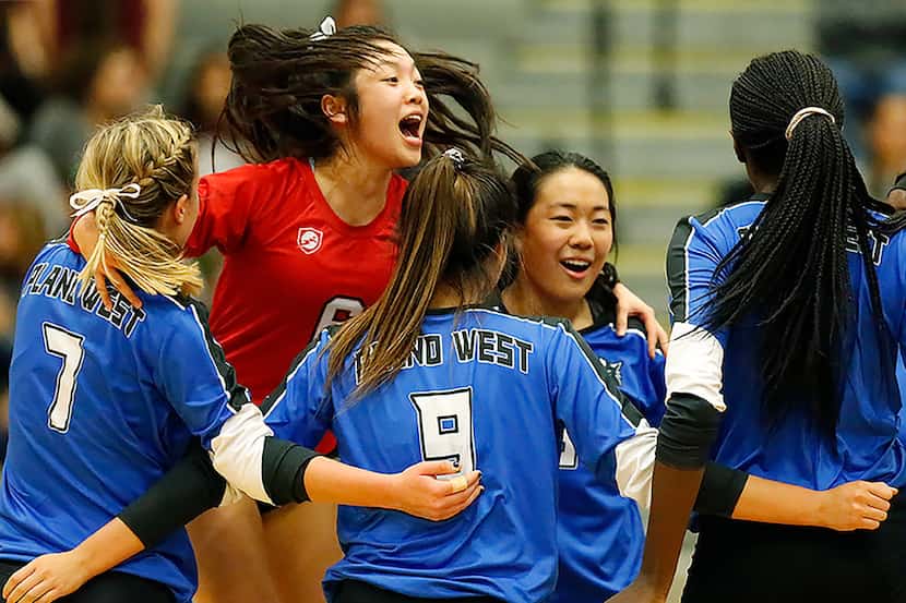 Plano West libero Haley Hoang (6) celebrates a point with teammates during a match against...