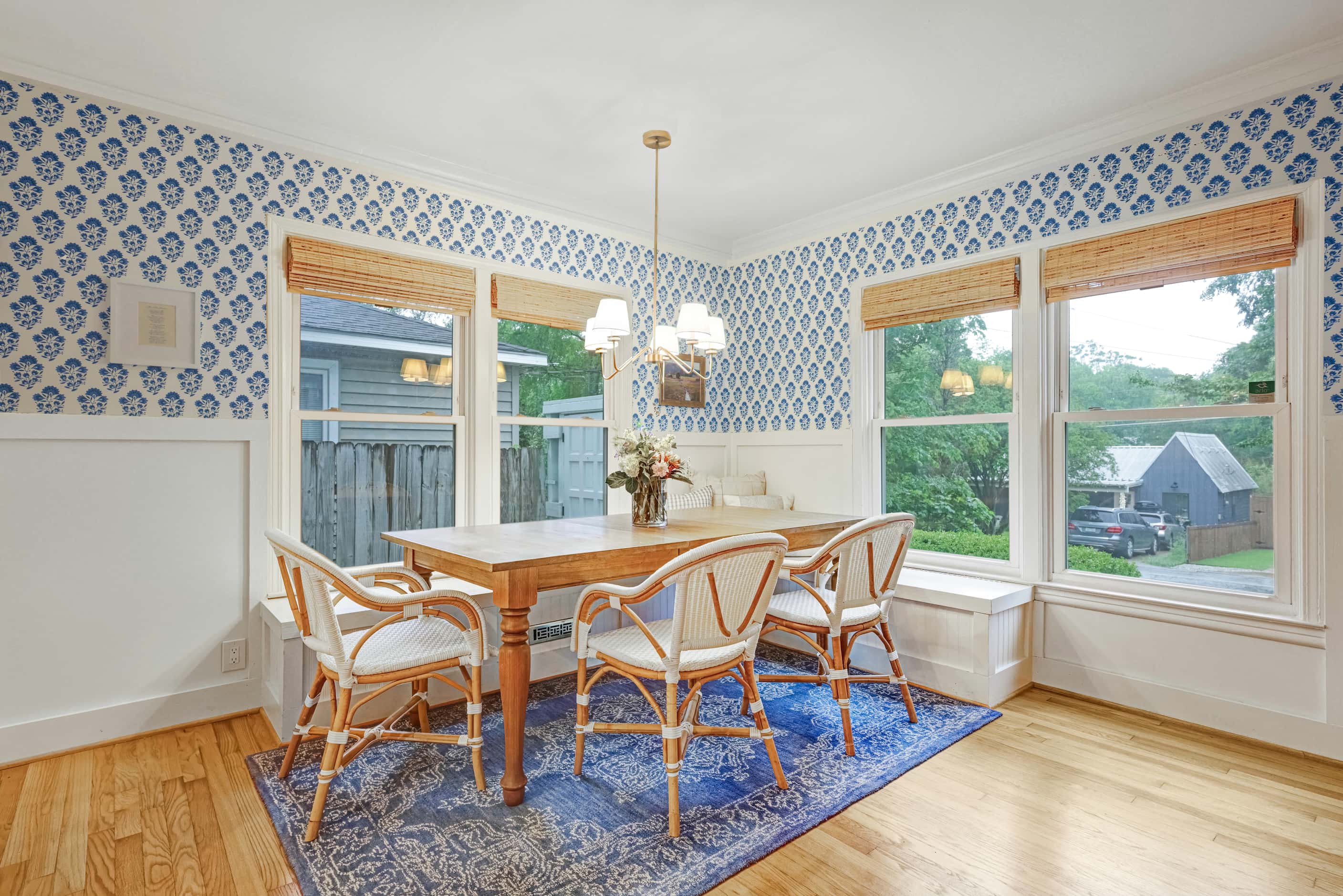 Blue and white wallpaper in the dining room adds a pop of color.
