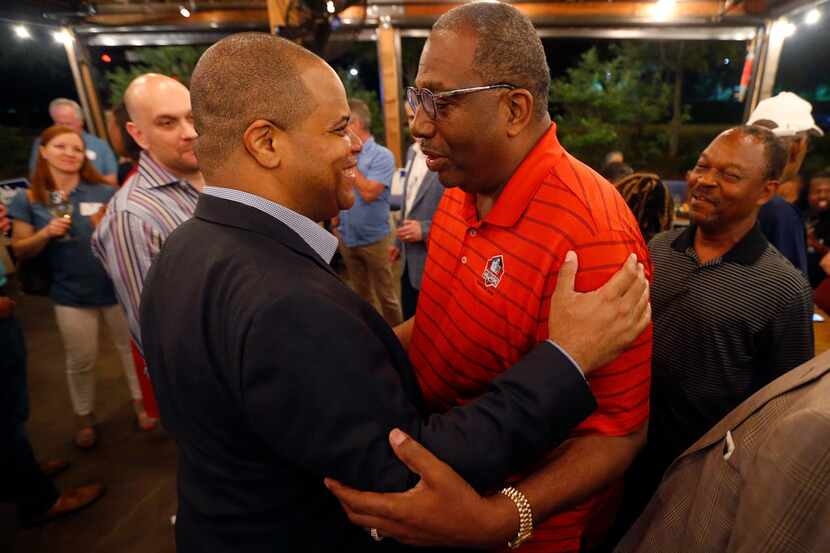 Dallas mayoral candidate and state Rep. Eric Johnson (left) is congratulated by state Sen....