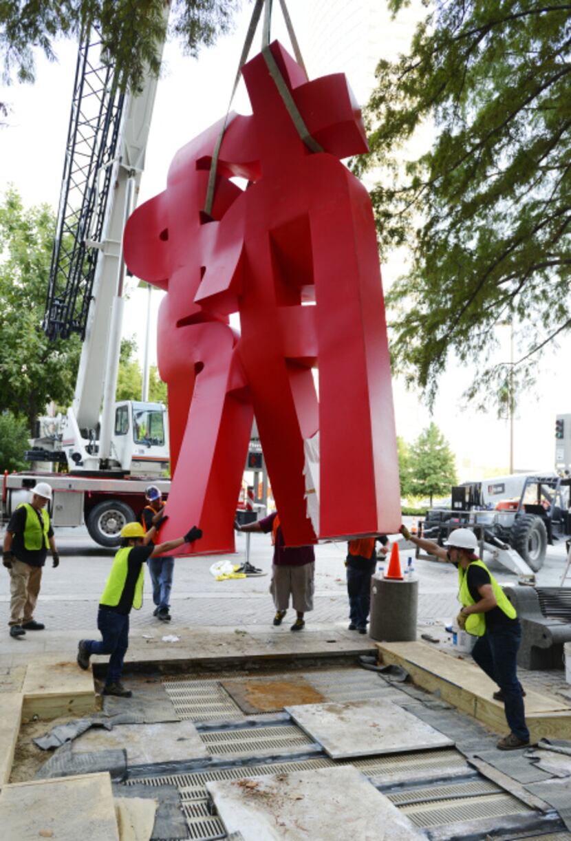 A Buddha sculpture is being installed as part of the Crow Collection's Sculpture Garden,...