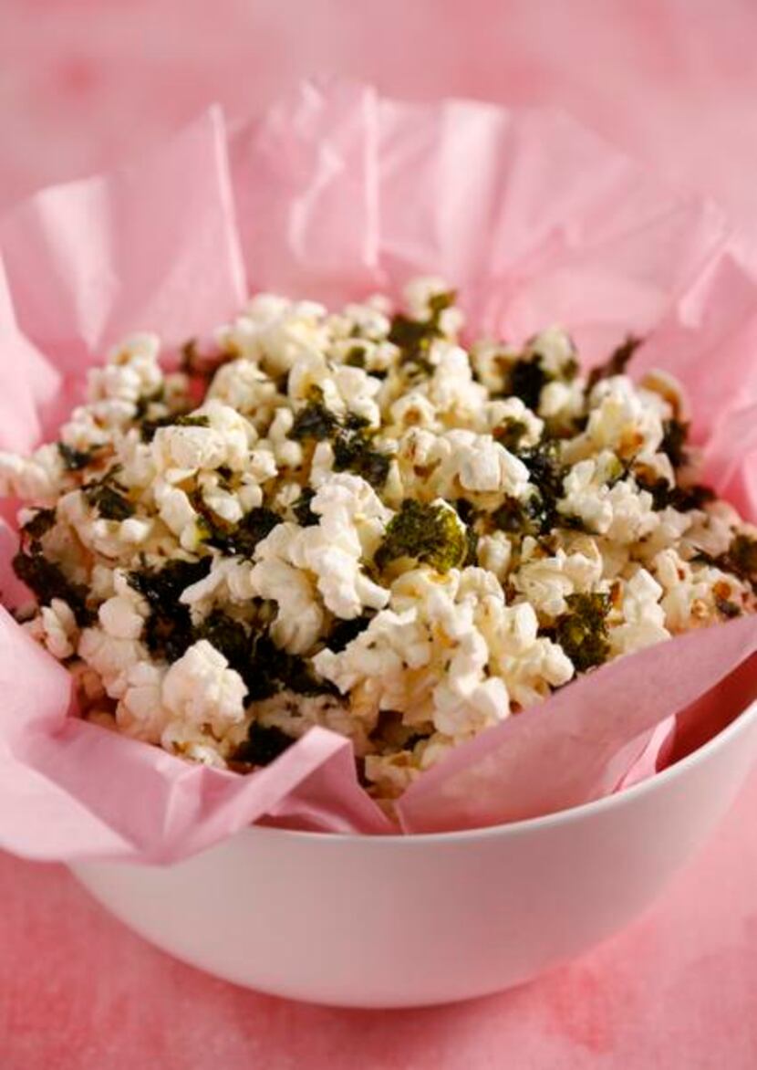 
Add roasted and crumbled nori snacks to popcorn. 

