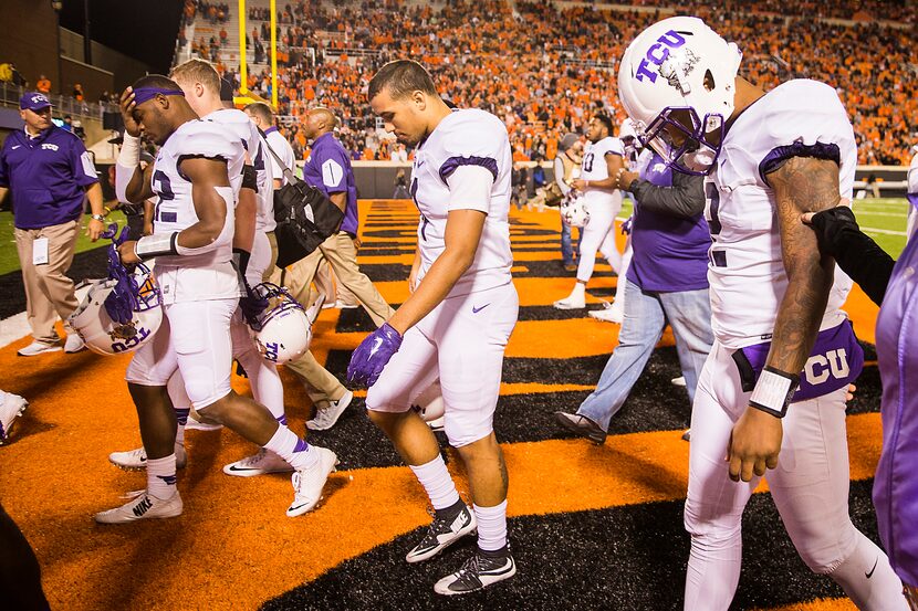 TCU quarterback Trevone Boykin (right) walks off with his teammates after a loss to Oklahoma...