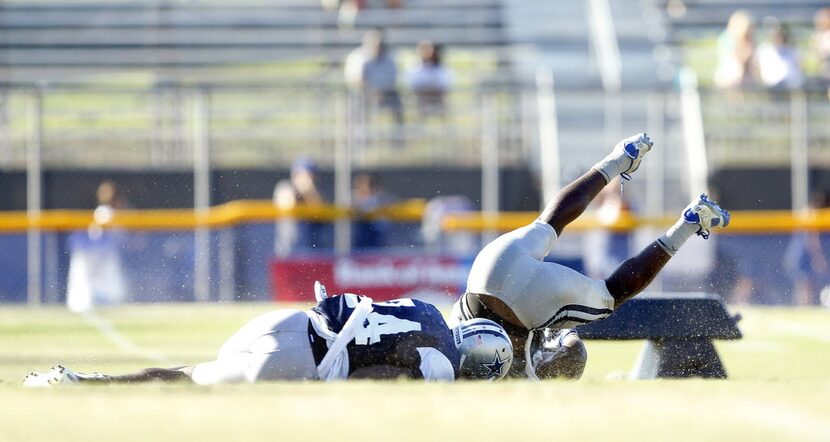 Dallas Cowboys cornerback Morris Claiborne (24) cuts the legs out from underneath wide...