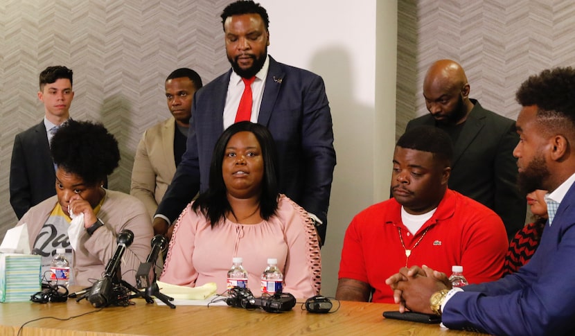 Amber Carr, left, wipes a tear as her sister Ashley Carr, center, talks about their sister,...