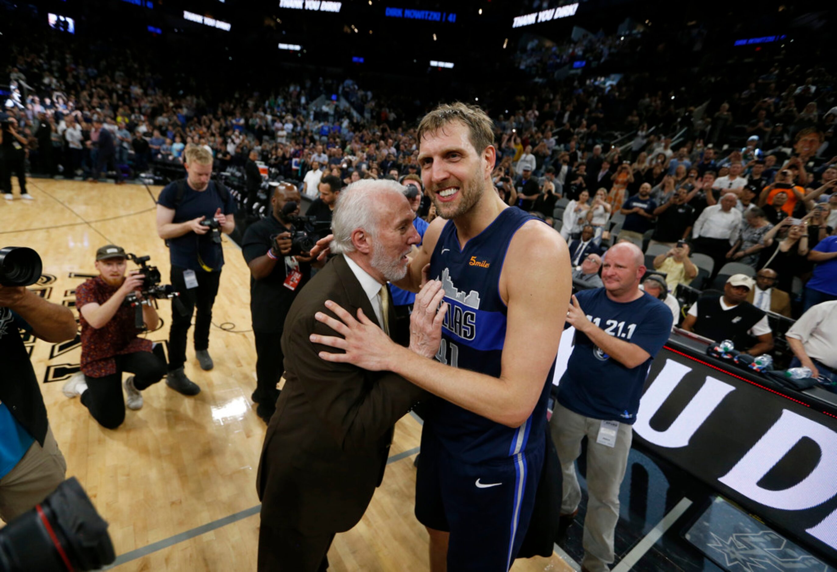 San Antonio Spurs head coach Gregg Popovich talks with Dallas Mavericks forward Dirk...