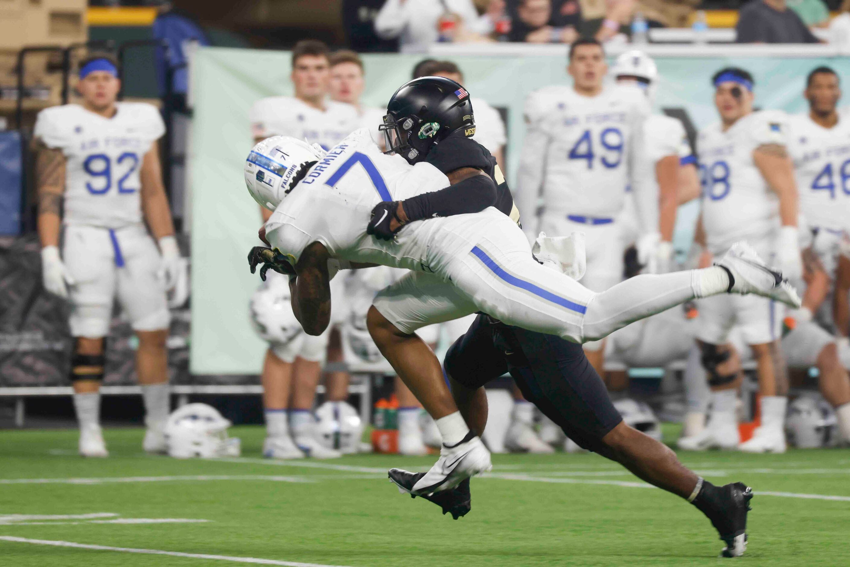 Air Force wide receiver David Cormier (7) misses to receive a pass while getting tackled by...