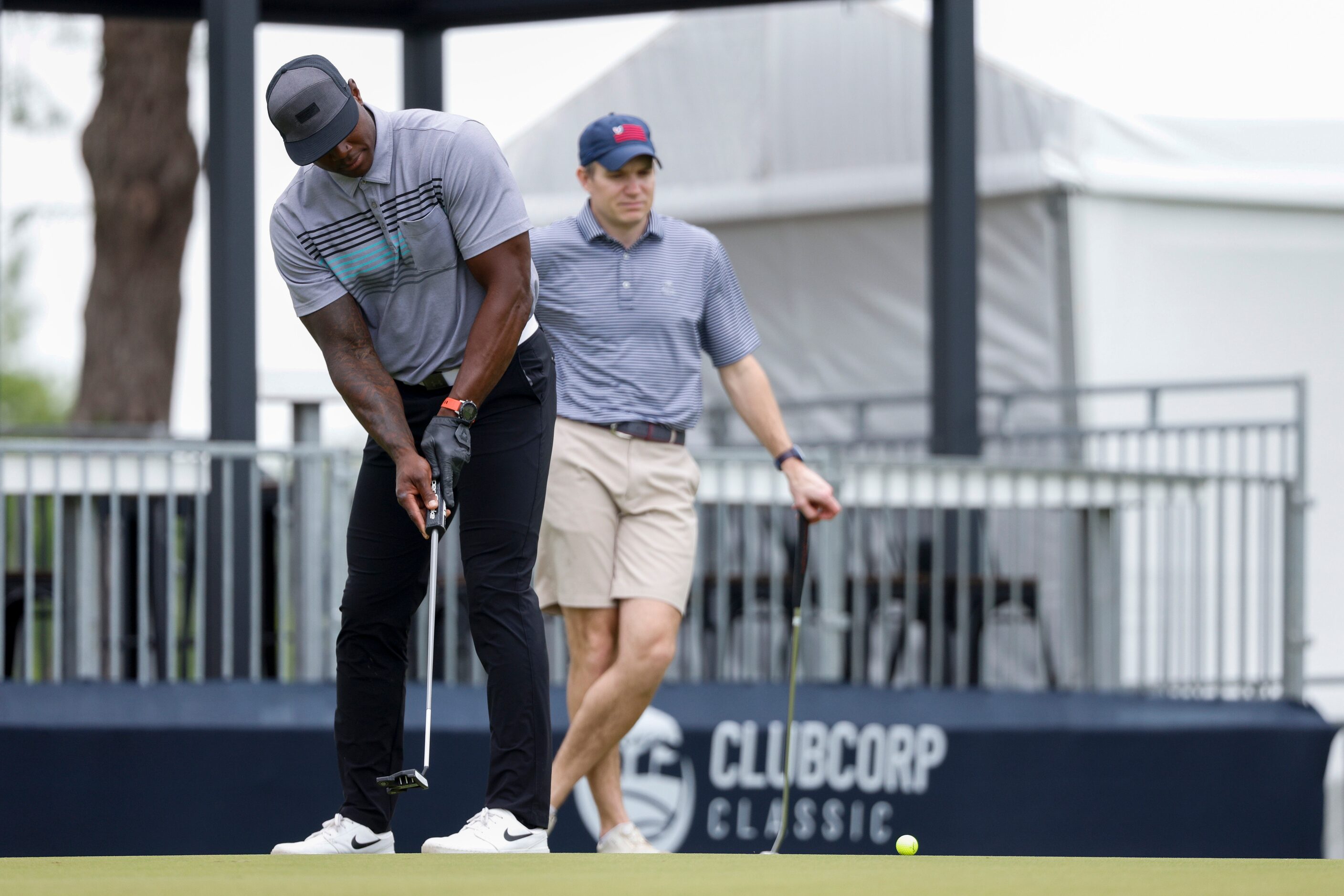 Former Dallas Cowboys player DeMarcus Ware watches his putt on the 16th green during the...