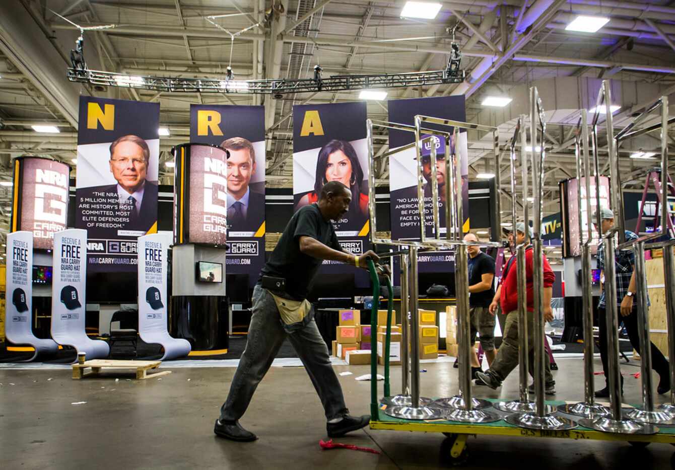 Exhibitors set up for the opening of the NRA Annual Meetings and Exhibits at the Kay Bailey...