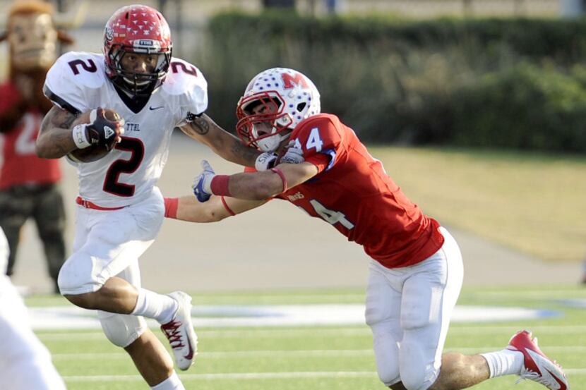 Cedar Hill's Laquvionte Gonzalez (2) stiff arms Waco Midway's Keith Efferson during the...