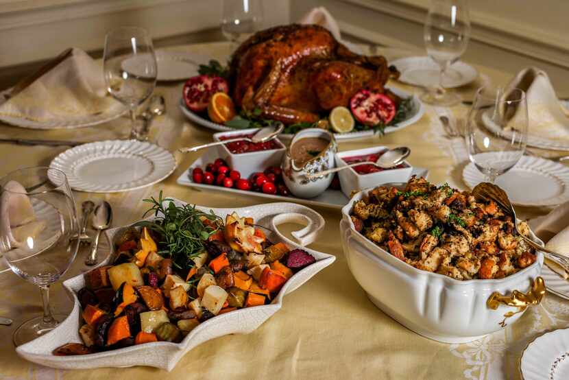 Thanksgiving dinner table with roasted root vegetables and traditional stuffing as side dishes 