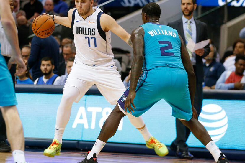 Dallas Mavericks guard Luka Doncic (77) dribbles the ball in front of Charlotte Hornets...