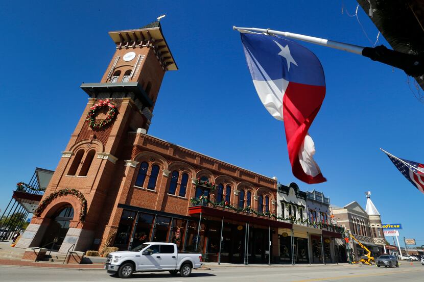 The Texas flag flies in front of the Grapevine Convention and Visitors Bureau building along...