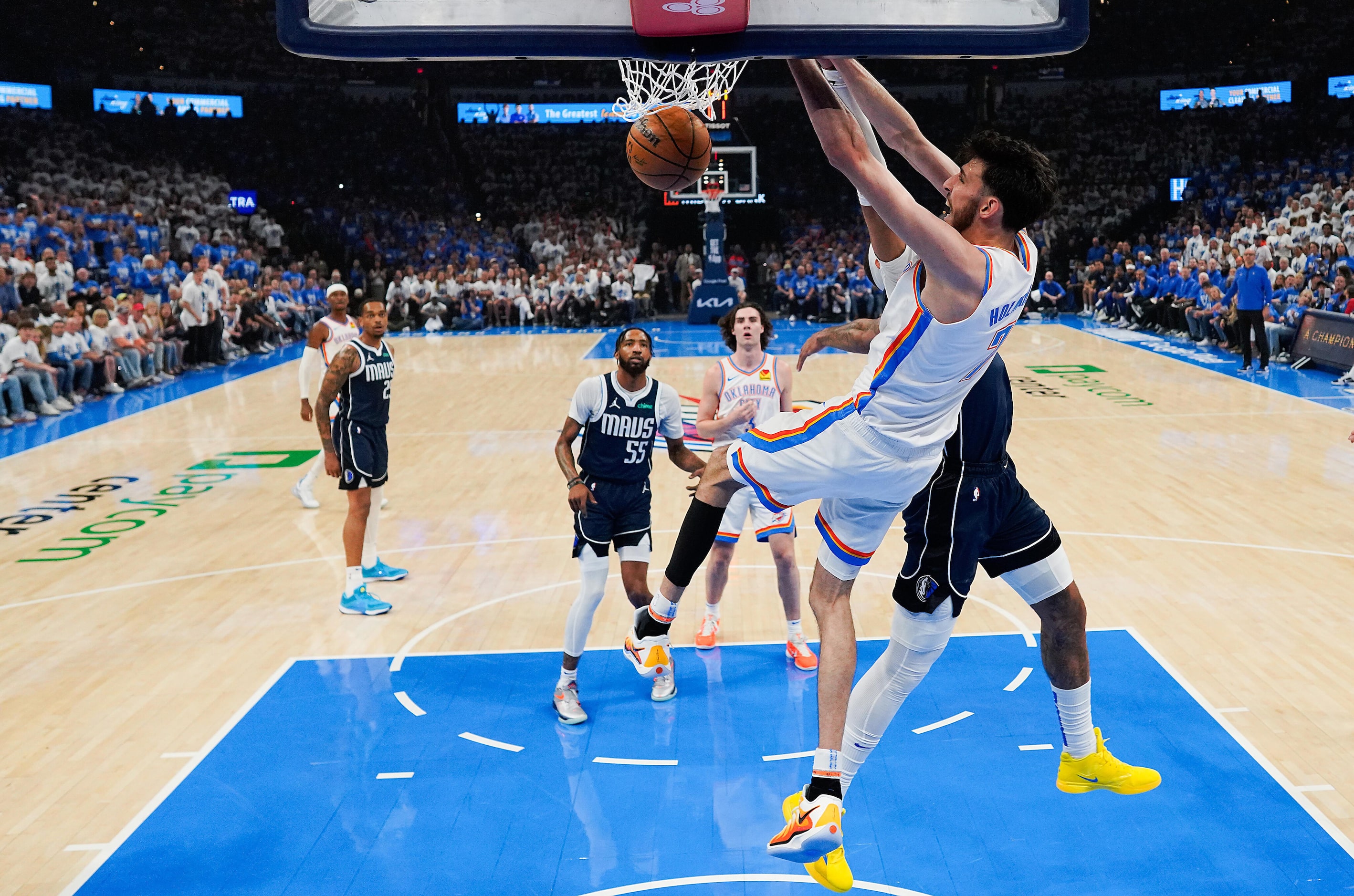 Oklahoma City Thunder forward Chet Holmgren (7) dunks the ball past Dallas Mavericks center...