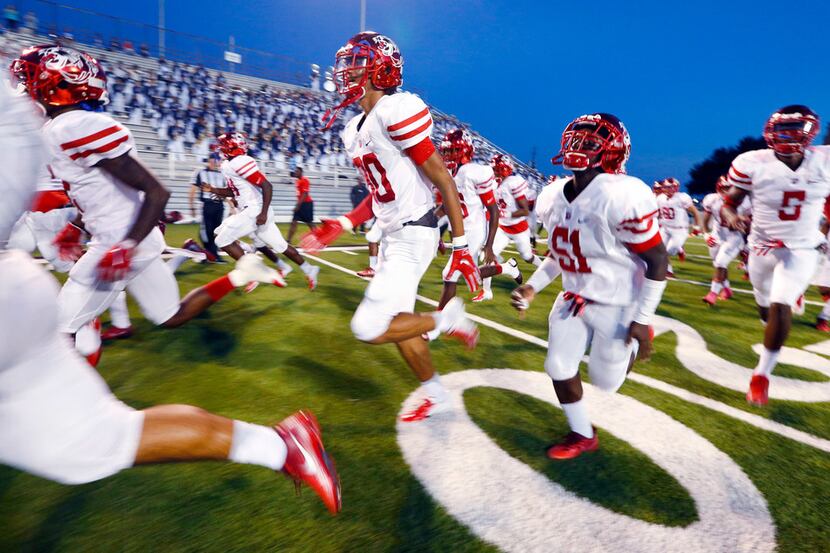 The Duncanville Panthers football team races onto the field to face Skyline at Forester...