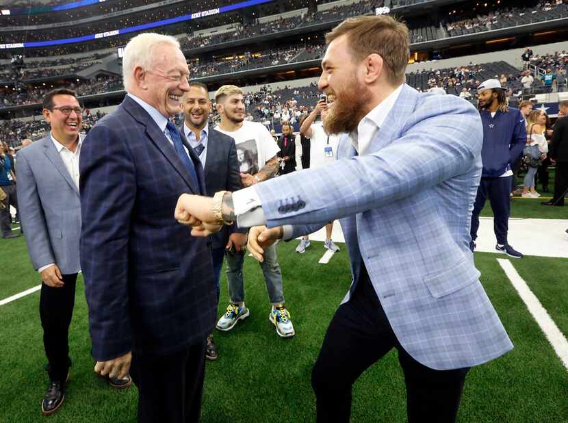 MMA fighter Conor McGregor of Ireland (right) throws up his fists as he jockeys with Dallas...