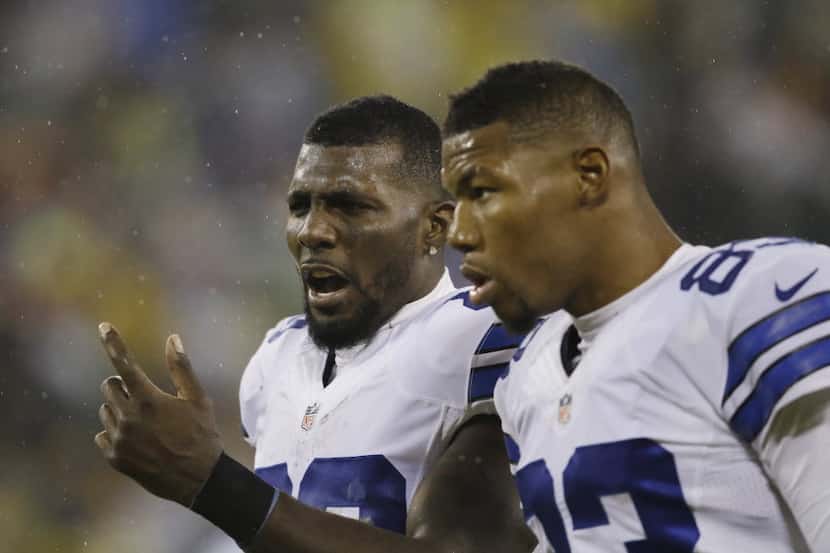 Dallas Cowboys' Dez Bryant talks to teammate Terrance Williams (83) after an NFL football...