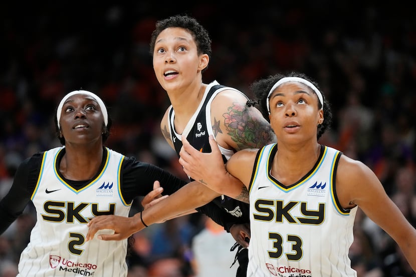 Phoenix Mercury center Brittney Griner, middle, is boxed out by the Chicago Sky's Kahleah...