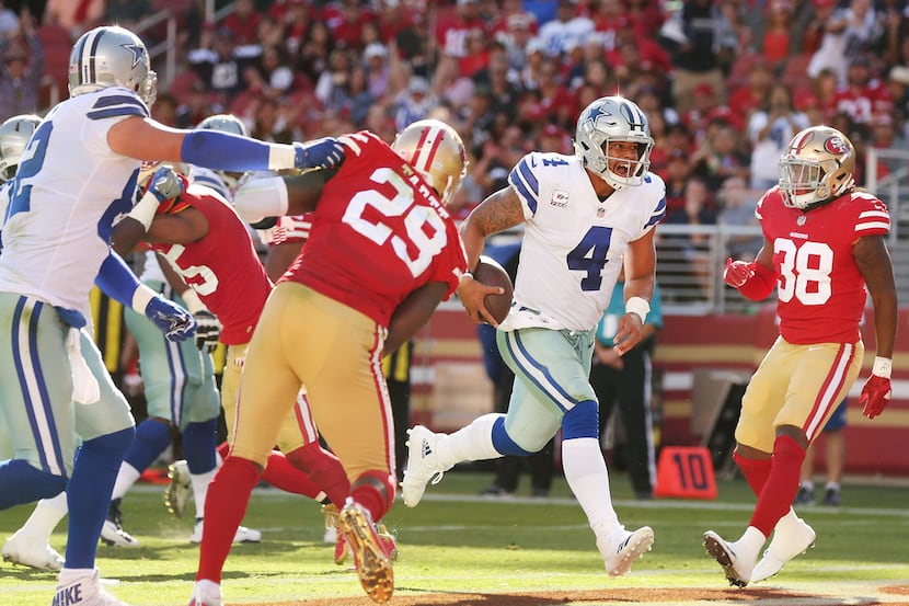 Dallas Cowboys quarterback Dak Prescott (4) rushes for a 2-yard touchdown in the fourth...