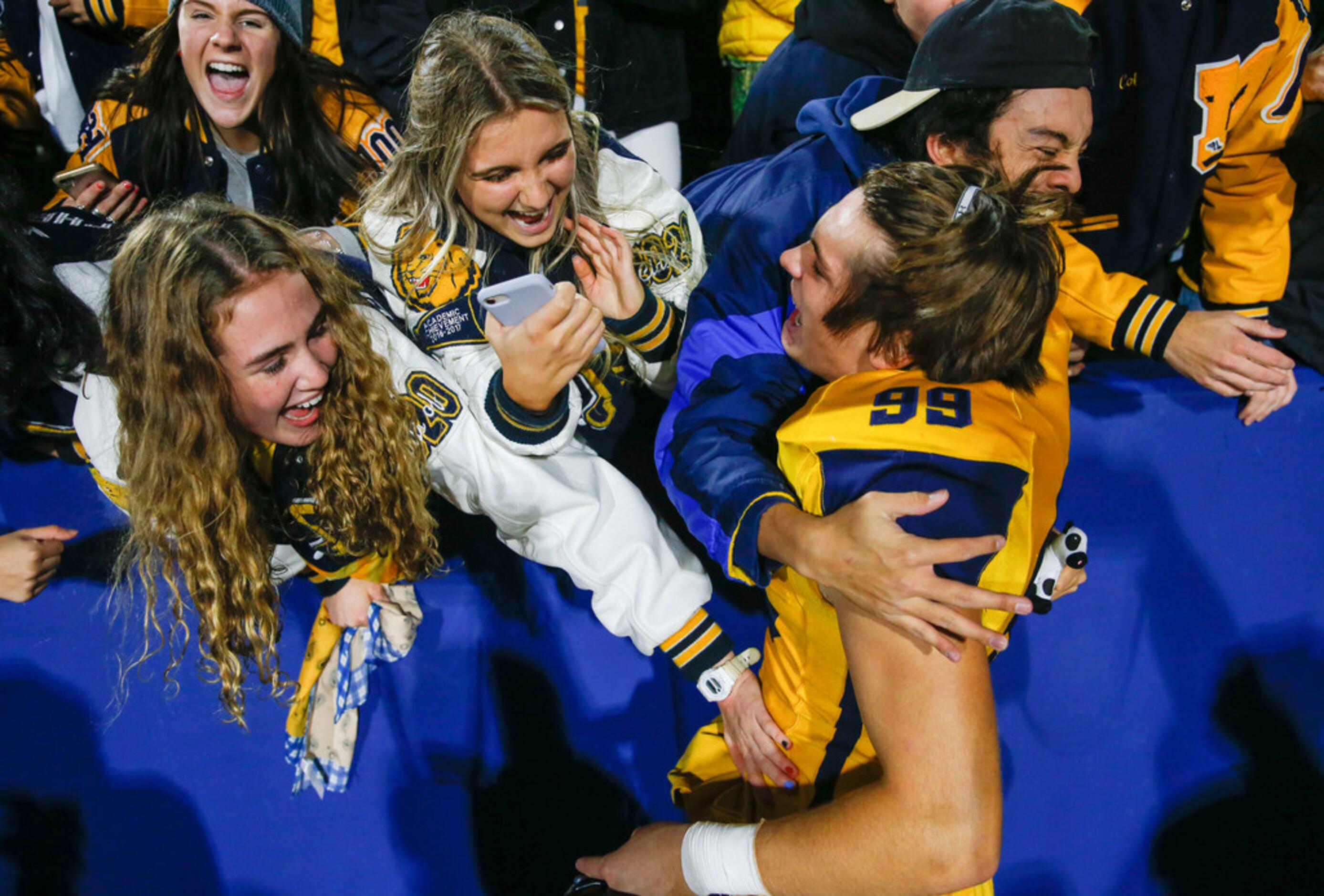 McKinney's Cavan Natal (99) celebrates with fans following their win over McKinney Boyd in a...