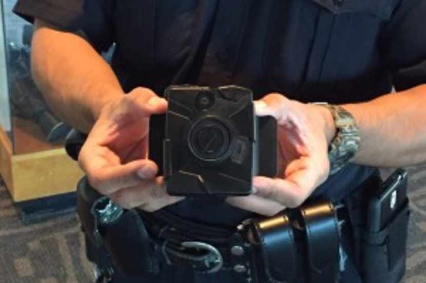  An officer holds a Taser Axon Flex body camera at Dallas Police Headquarters on Sept. 1,...