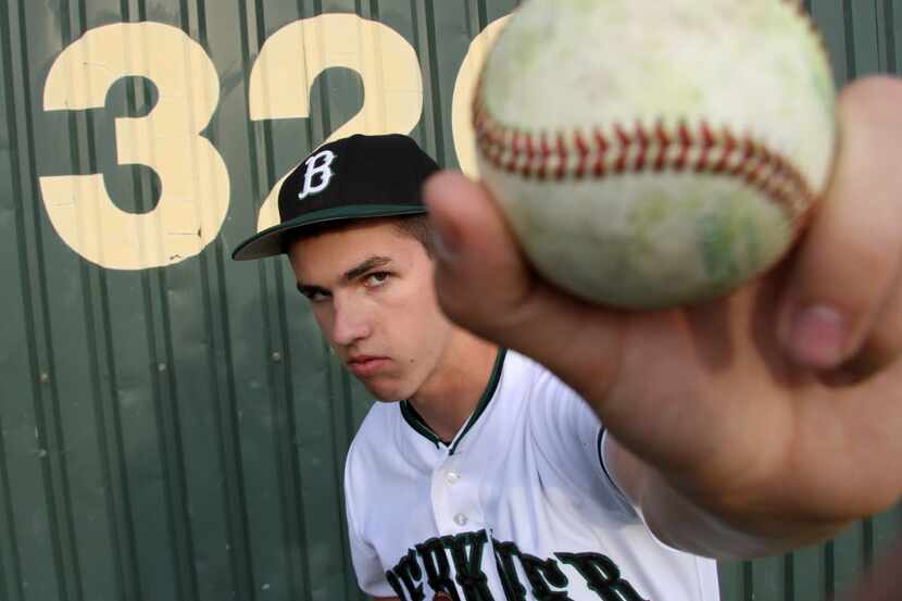 Richardson Berkner senior pitcher Jacob Patterson shows the finger placement for his...