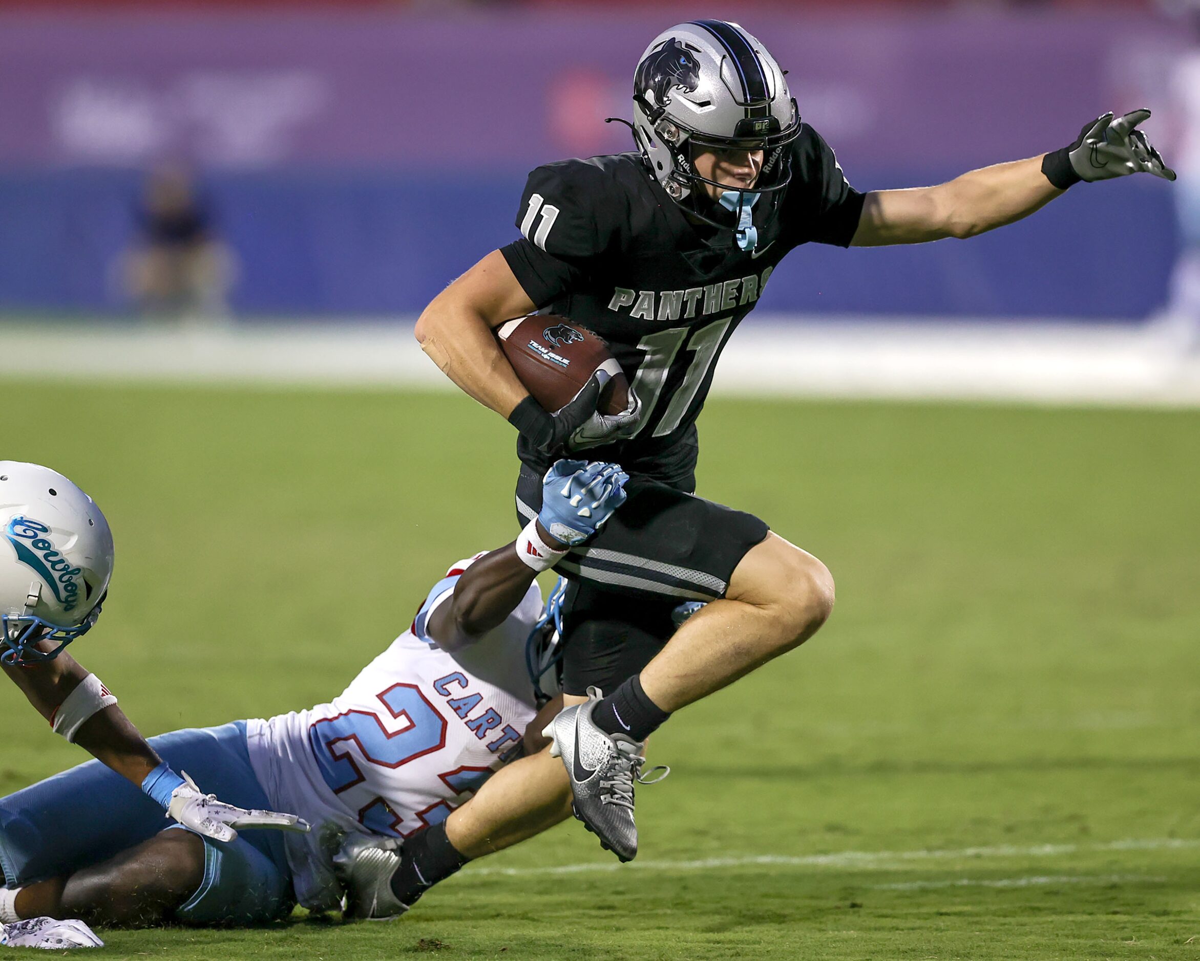 Frisco Panther Creek wide receiver Cristian Trickett (11) tries to break away from Dallas...