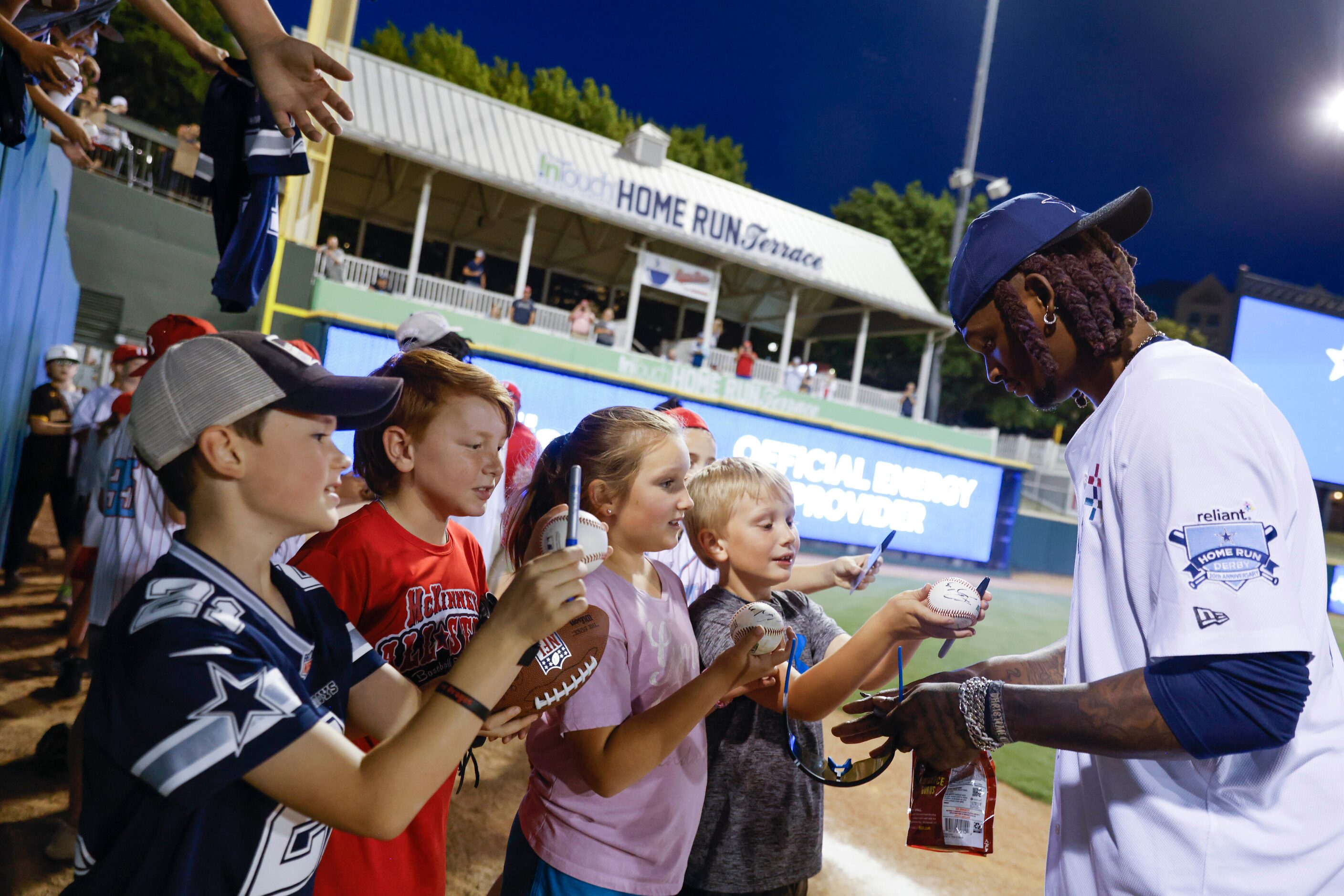 Dallas Cowboys wide receiver CeeDee Lamb gives autograph to young fans after annual home run...